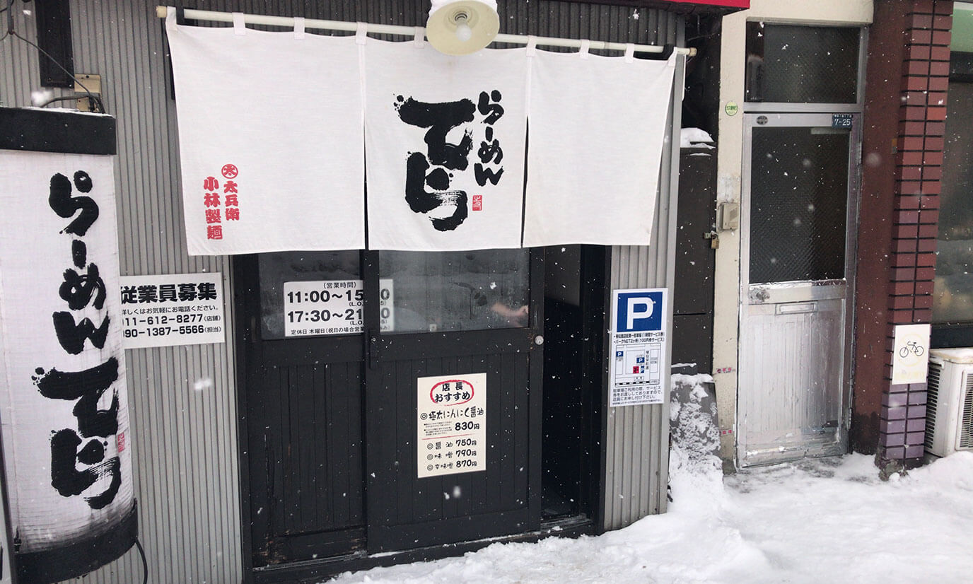 JR琴似駅から徒歩5分の場所に位置しています。入り口には白いのぼりとのれんがあります